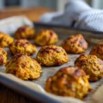 Close-up of freshly baked 4-ingredient Tuna & Pumpkin Cat Bites on a baking sheet.