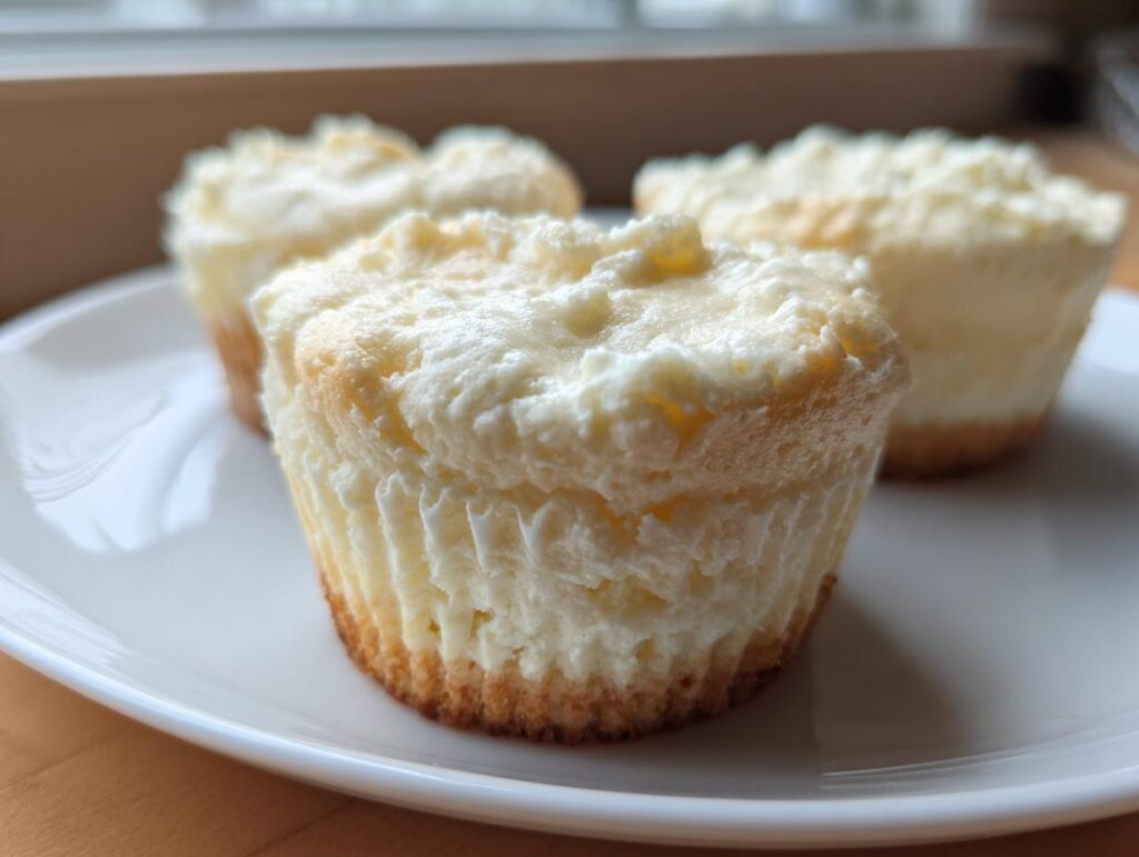 Close-up of fluffy Two-Ingredient Cheesecake Cups on a white plate, perfect for a quick dessert.