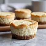 Close-up of a delicious Viral Two-Ingredient Cheesecake Cups, showing the creamy filling and crust.