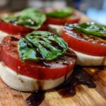Close-up of Classic Caprese Salad with Aged Balsamic, featuring tomato, mozzarella, basil, and balsamic glaze.