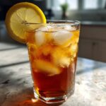 Glass of Cold Brew Lemonade with ice and a lemon slice, perfect for a refreshing drink.