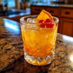 Close-up of a Mai Tai cocktail with ice, orange slice, and cherry. Perfect for an Easy Mai Tai Recipe.