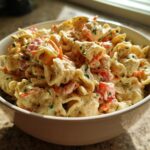Bowl of healthy pasta salad with Greek yogurt, vegetables, and herbs. This is a healthy pasta salad Greek yogurt recipe.