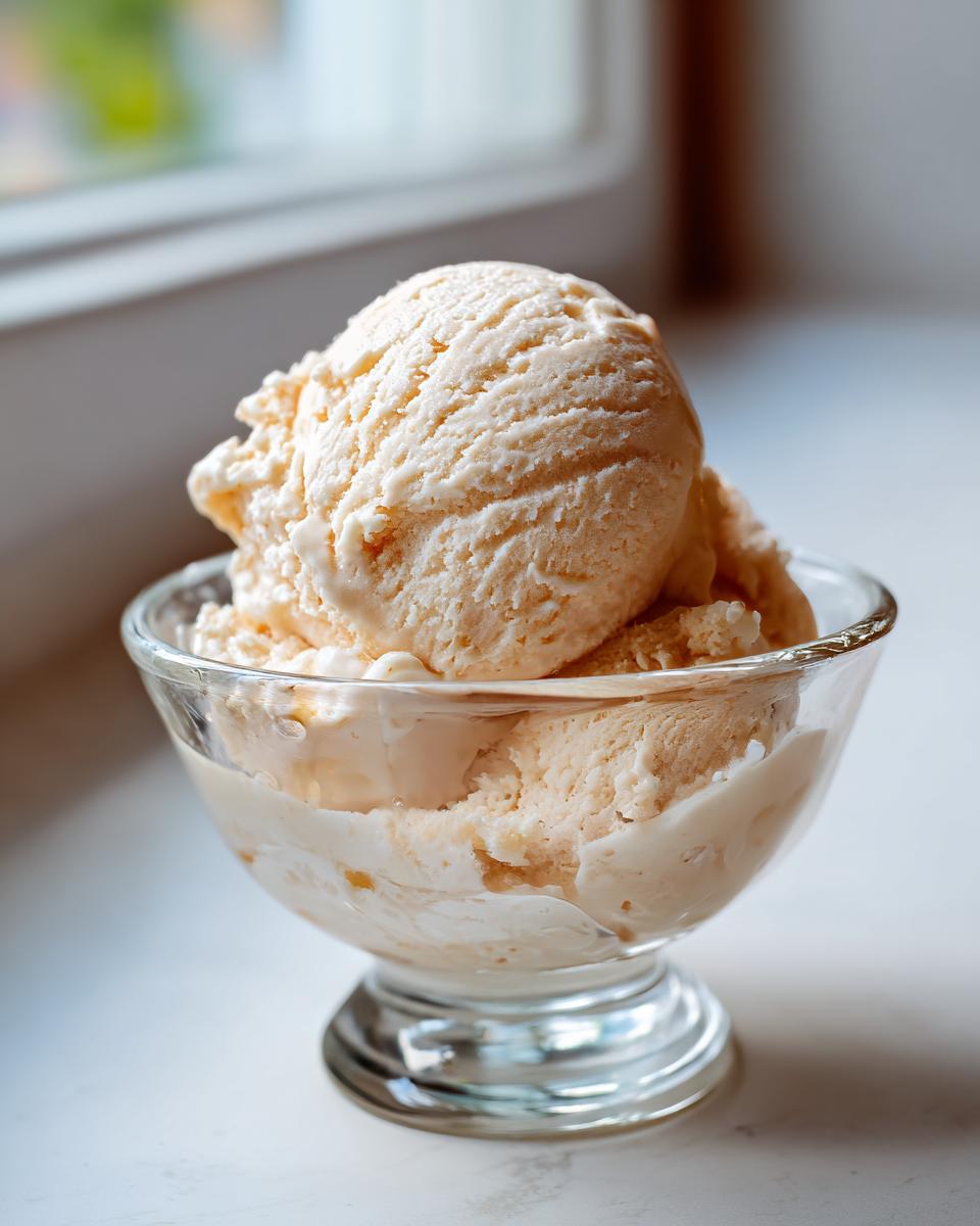 Close-up of a glass bowl filled with scoops of Honey Lavender Ice Cream.
