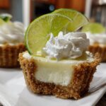 Close-up of a mini Key Lime Pie topped with whipped cream and lime slices.