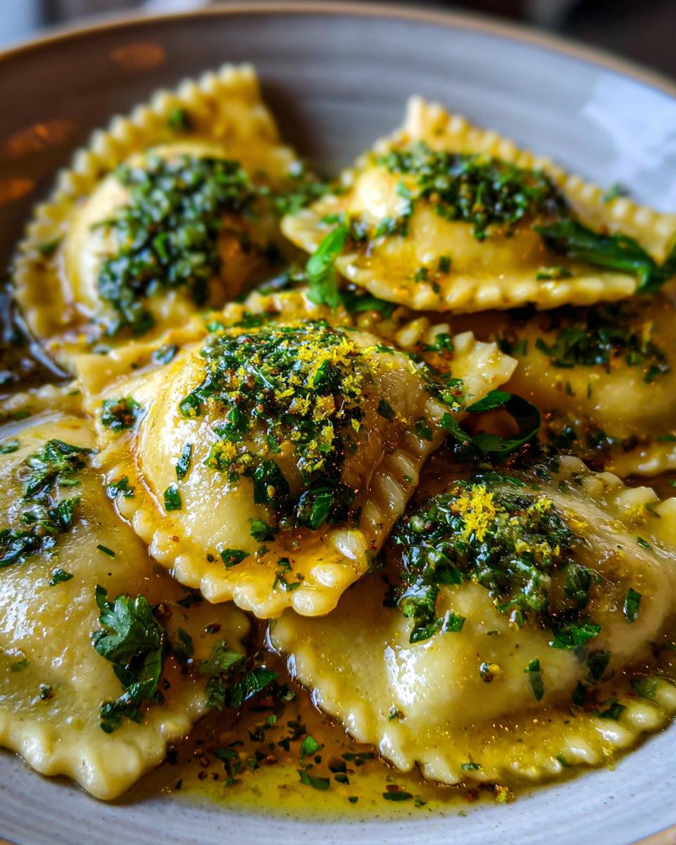 Close-up of Ricotta & Lemon Ravioli with Brown Butter, garnished with herbs and lemon zest.