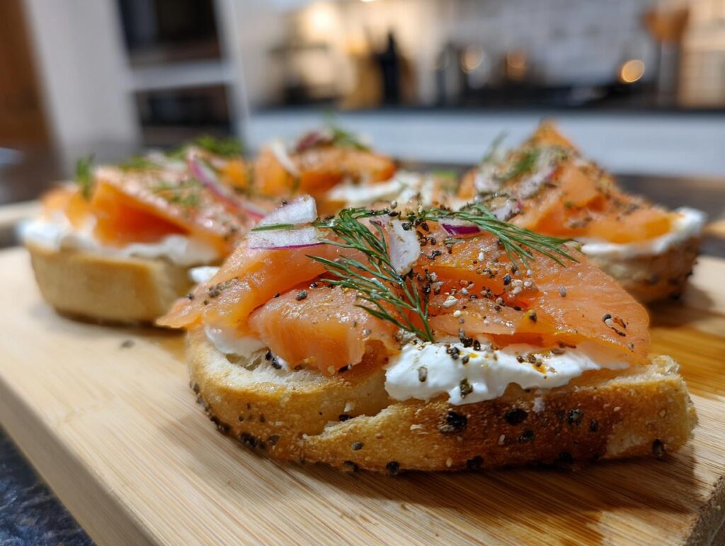 Close-up of Smoked Salmon & Cream Cheese Bagel Board with fresh dill and red onion.