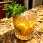 Close-up of a refreshing summer cocktail with ice, fruit, and mint, perfect for Summer Cocktails That Anyone Can Mix Up at Home.